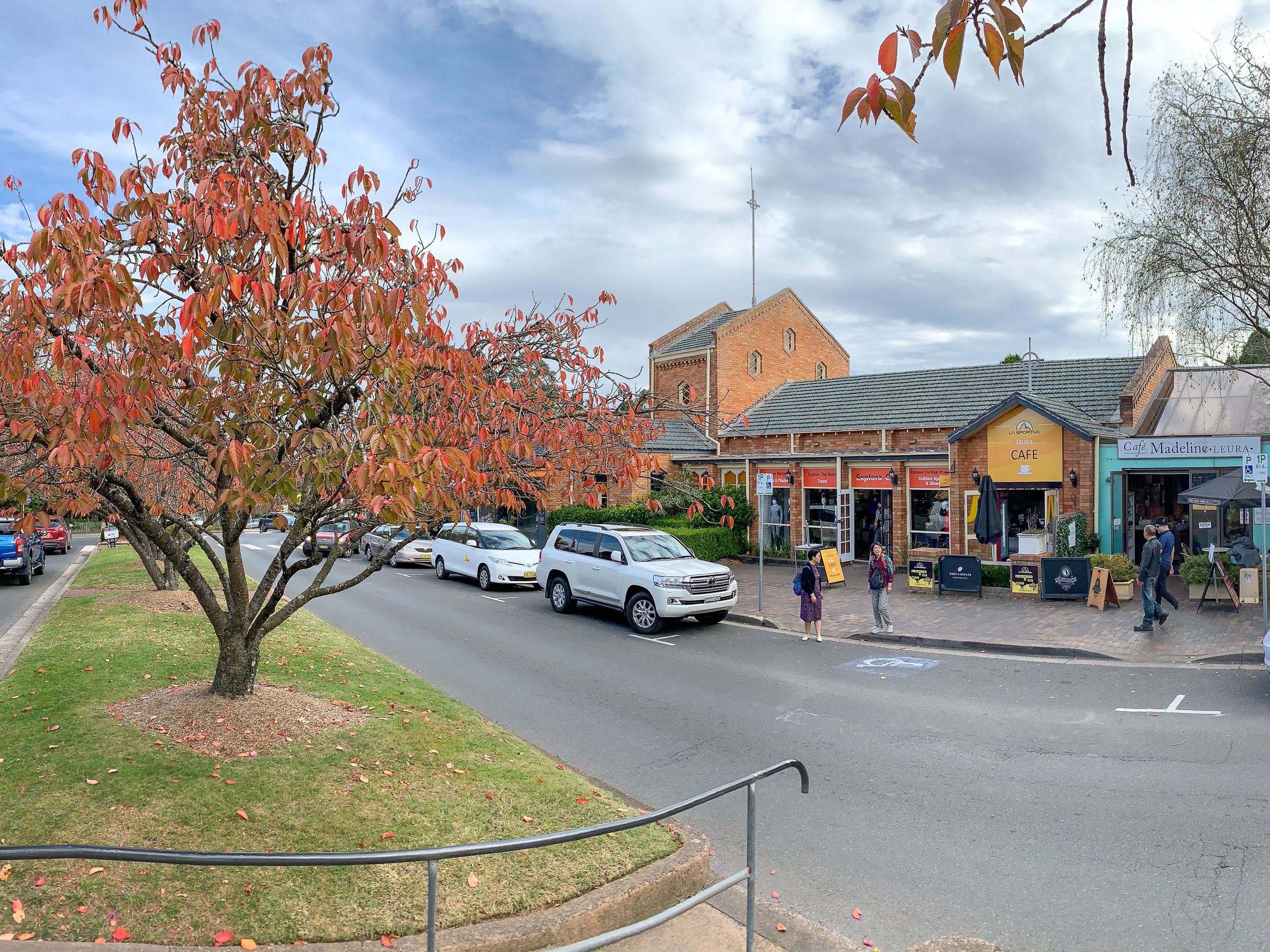 Autumn colors in Leura, with vibrant red, orange, and yellow leaves covering the streets and trees in the Blue Mountains.
