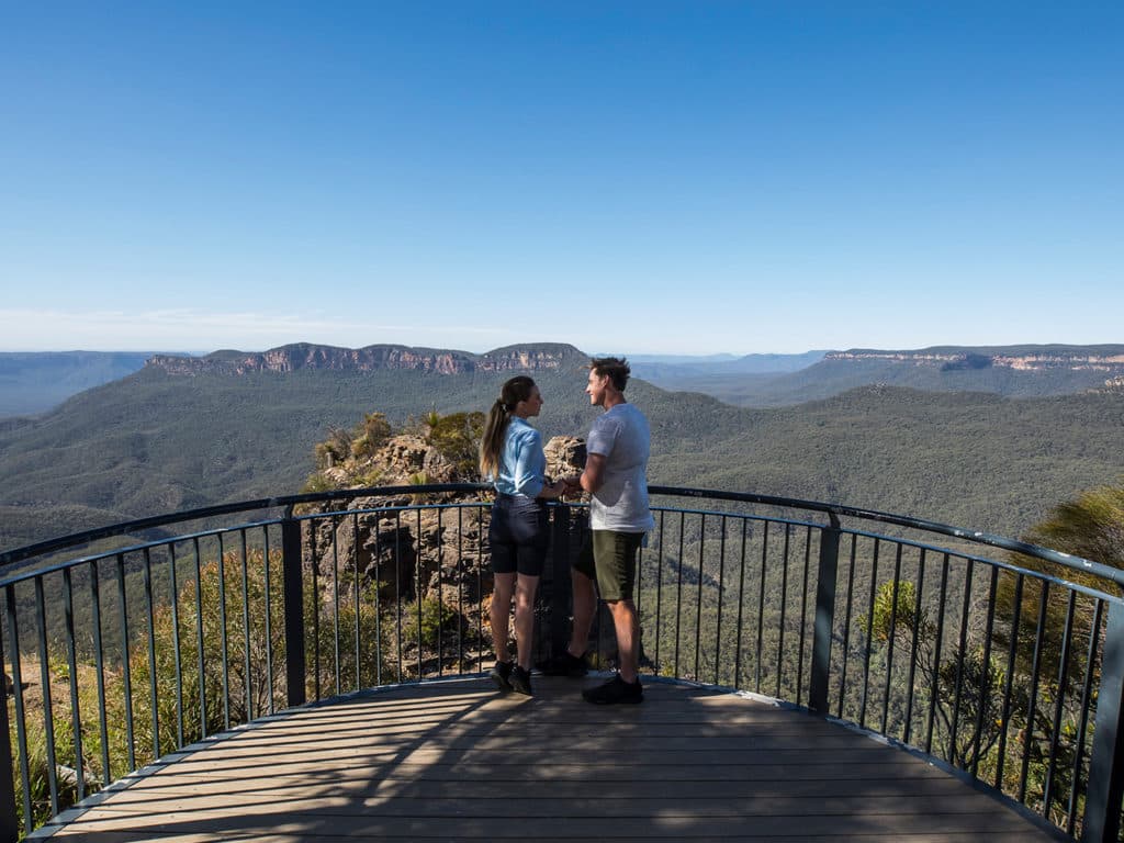 Couple overlooking Jamison Valley from a Katoomba lookout, Blue Mountains