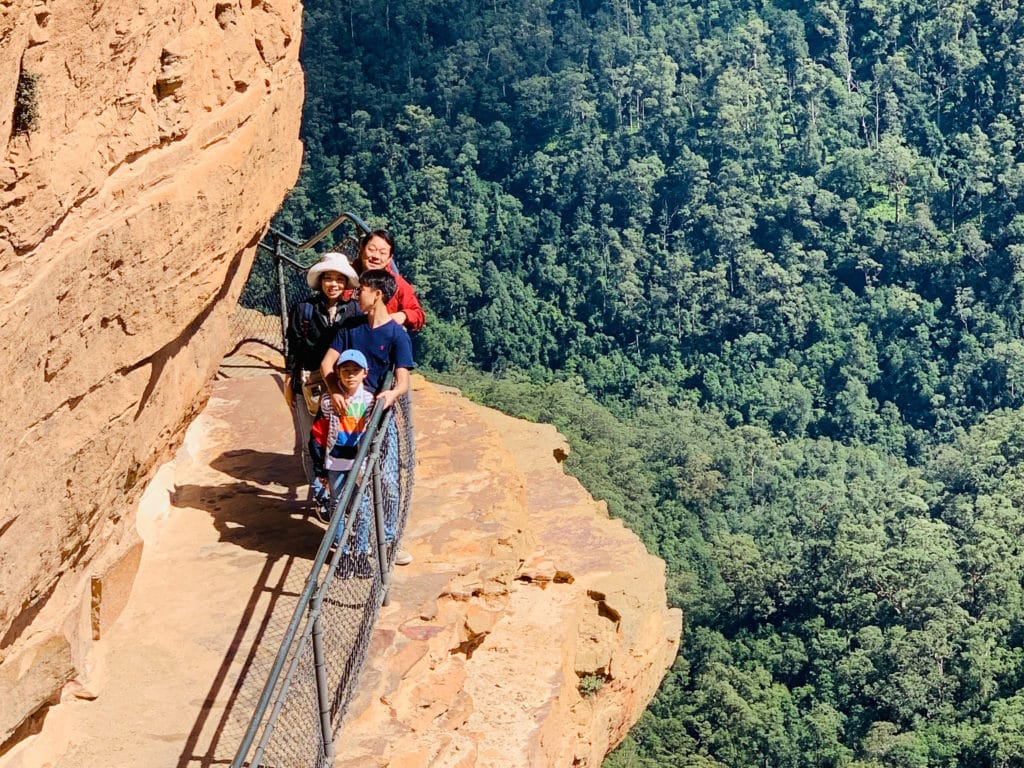 A breathtaking view from the cliff’s edge at Wentworth Falls, capturing the waterfall and the surrounding lush landscape of the Blue Mountains.